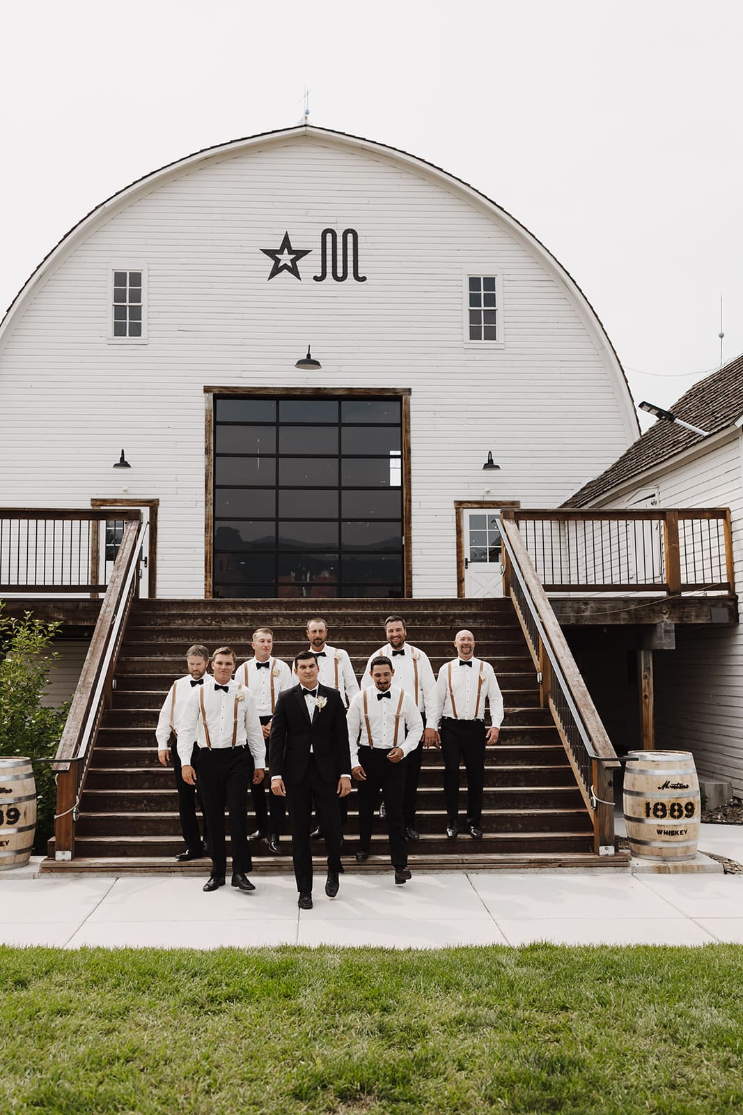 Groom and groomsmen strutting down the stairs towards their bozeman wedding photographer