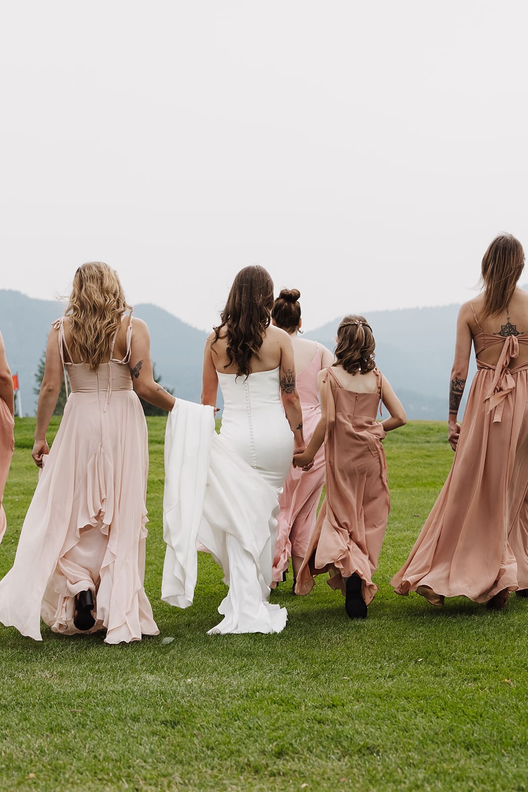 Bride and bridesmaids walking at montana wedding 