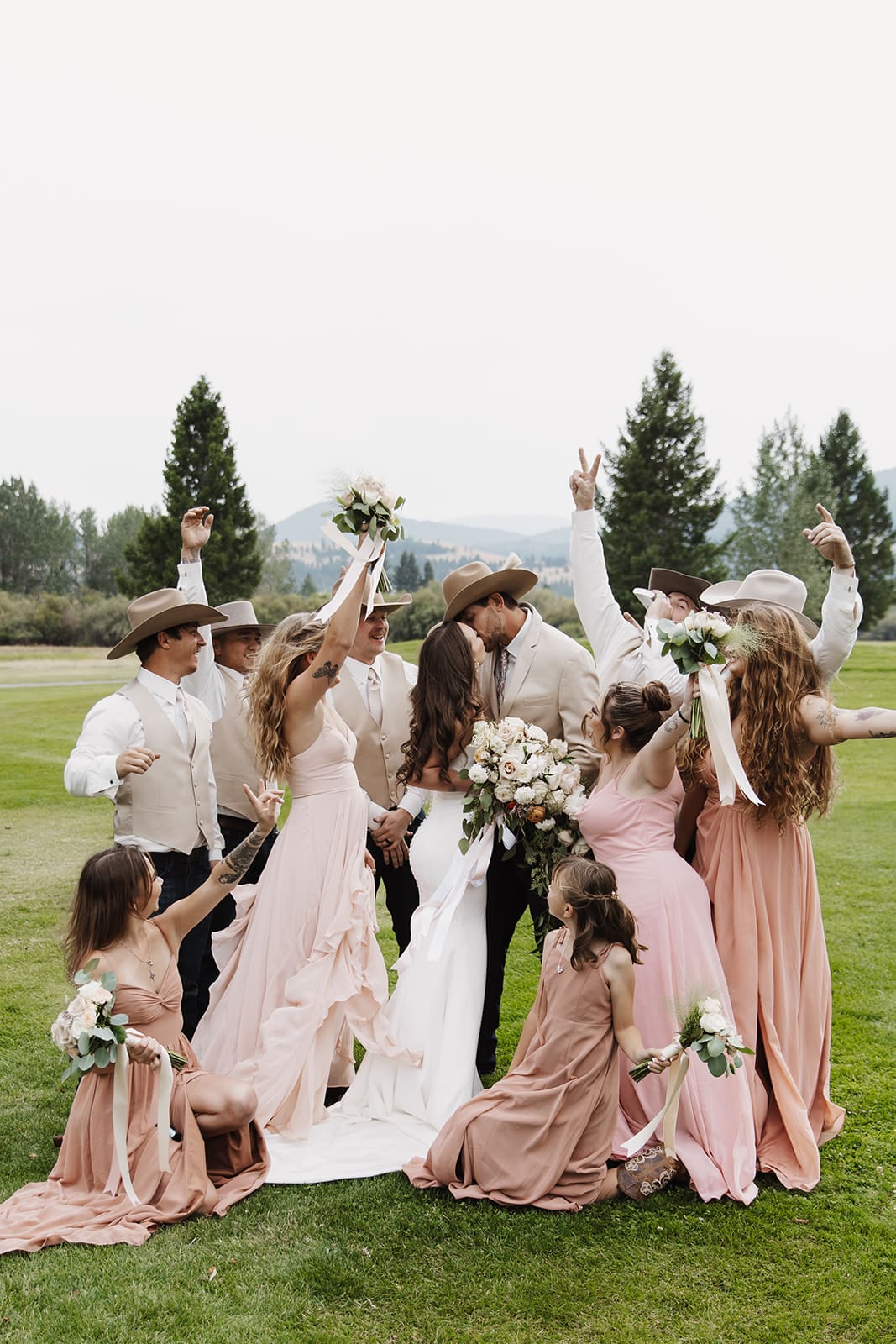Bridal party surrounding bride and groom at montana wedding