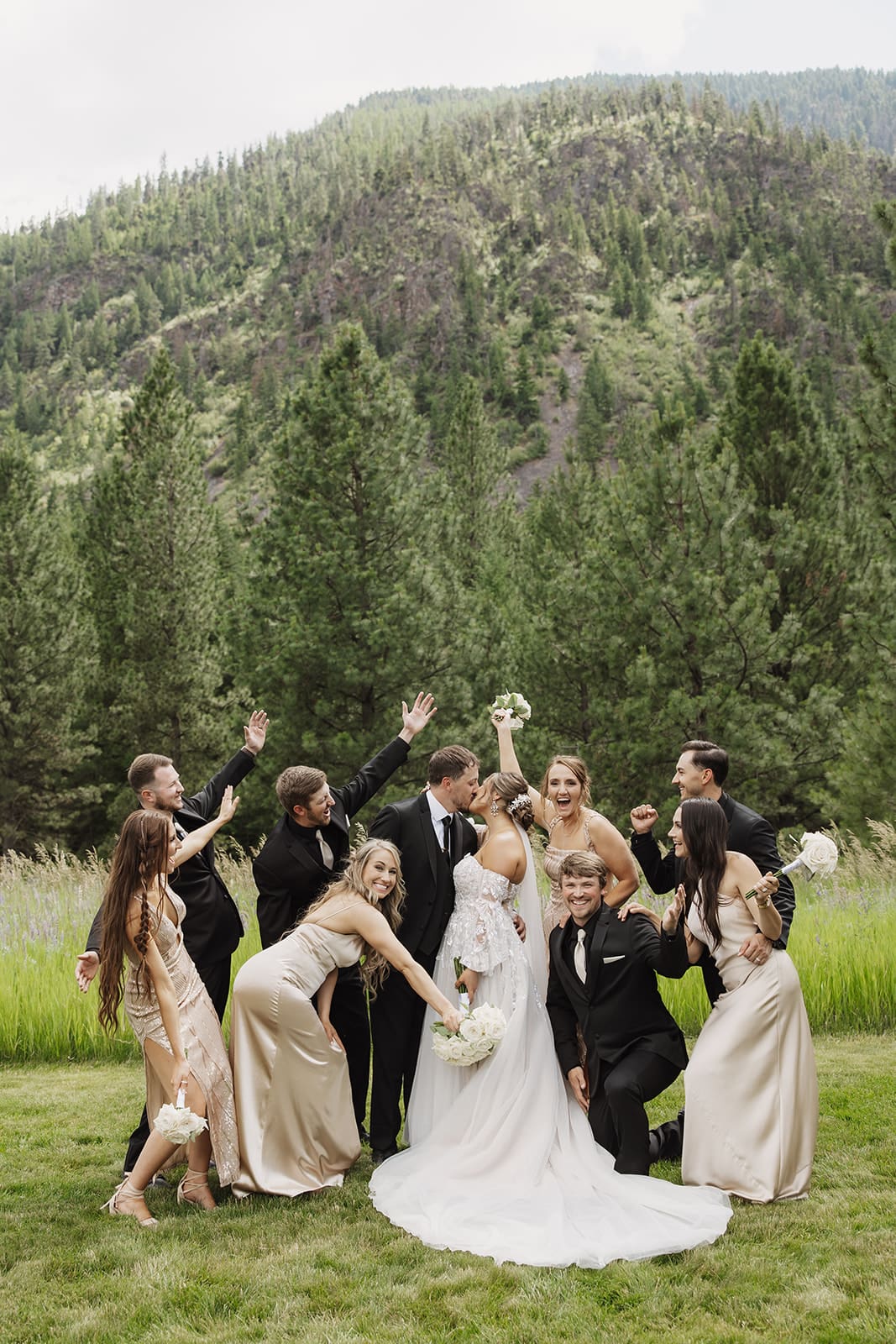 Bridal party celebrating at The White Raven wedding venue near Missoula, Montana, with elegant attire, natural scenery, and joyful moments captured by Frazier & Co.