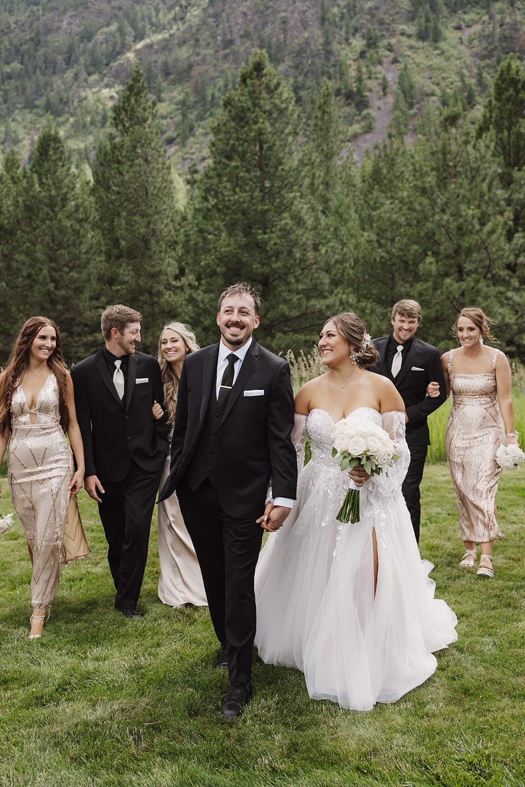 Bridal party celebrating at The White Raven wedding venue near Missoula, Montana, with elegant attire, natural scenery, and joyful moments captured by Frazier & Co.