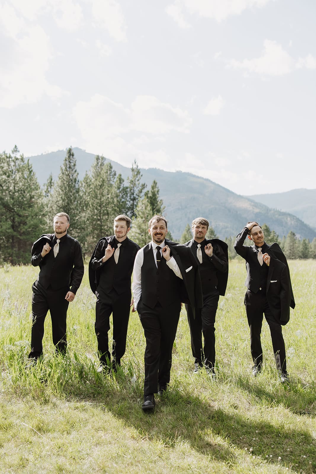 groomsmen and groom celebrating at The White Raven wedding venue near Missoula, Montana, with elegant attire, natural scenery, and joyful moments captured by Frazier & Co.