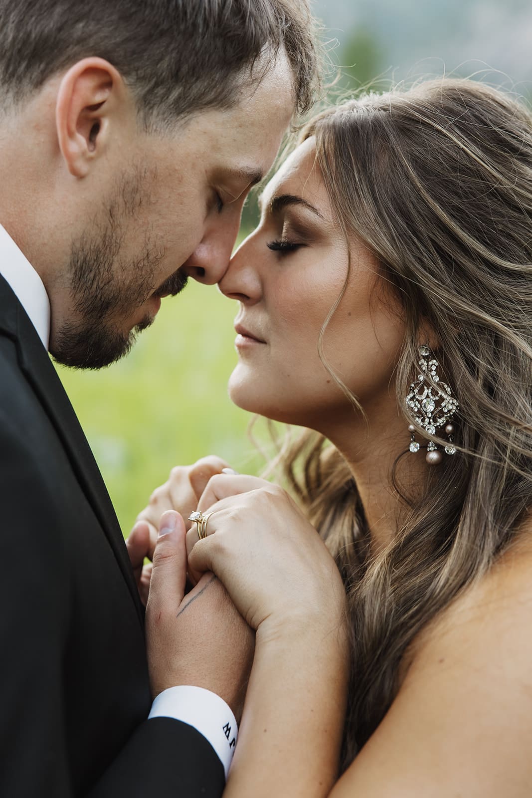 Close up of Bride and groom being intimate at golden hour portraits at The White Raven near Missoula, Montana, bathed in warm sunset light and surrounded by mountain views.