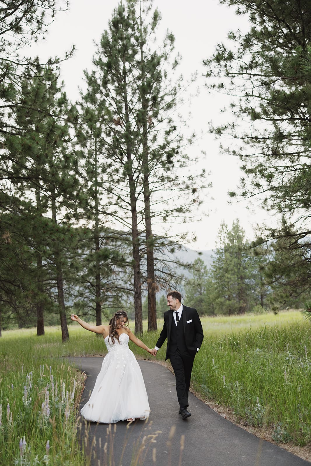 Mr. and Mrs. Walker celebrating with their wedding party at The White Raven, captured by Missoula wedding photographer Frazier & Co