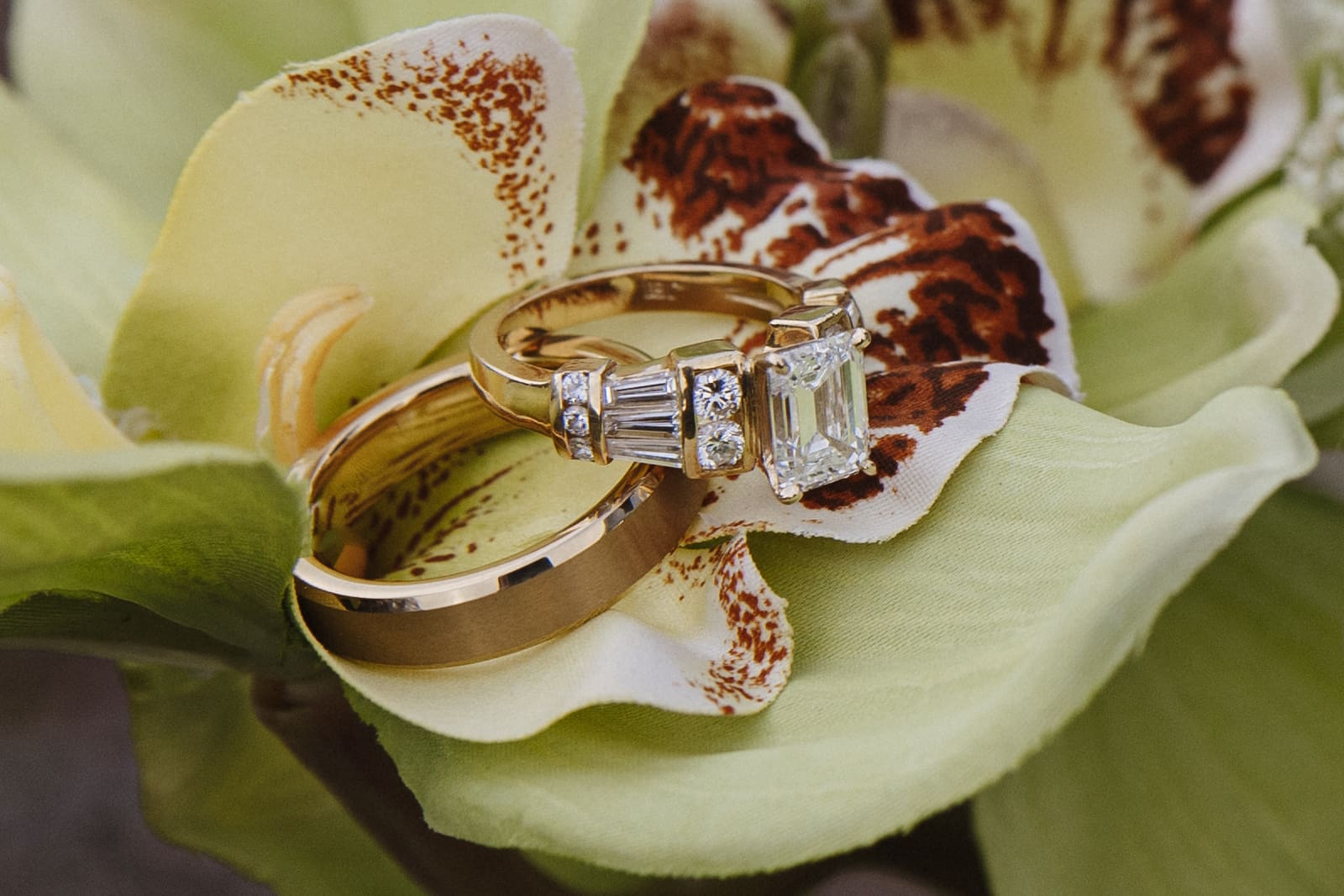Bride and grooms rings sitting on their modern florals