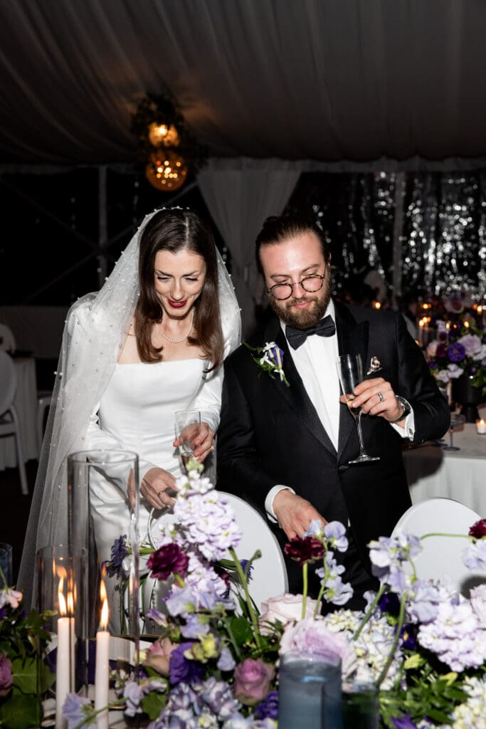 Bride and groom cutting their wedding cake during the Biltmore Estate reception, photographed by a Biltmore wedding photographer.