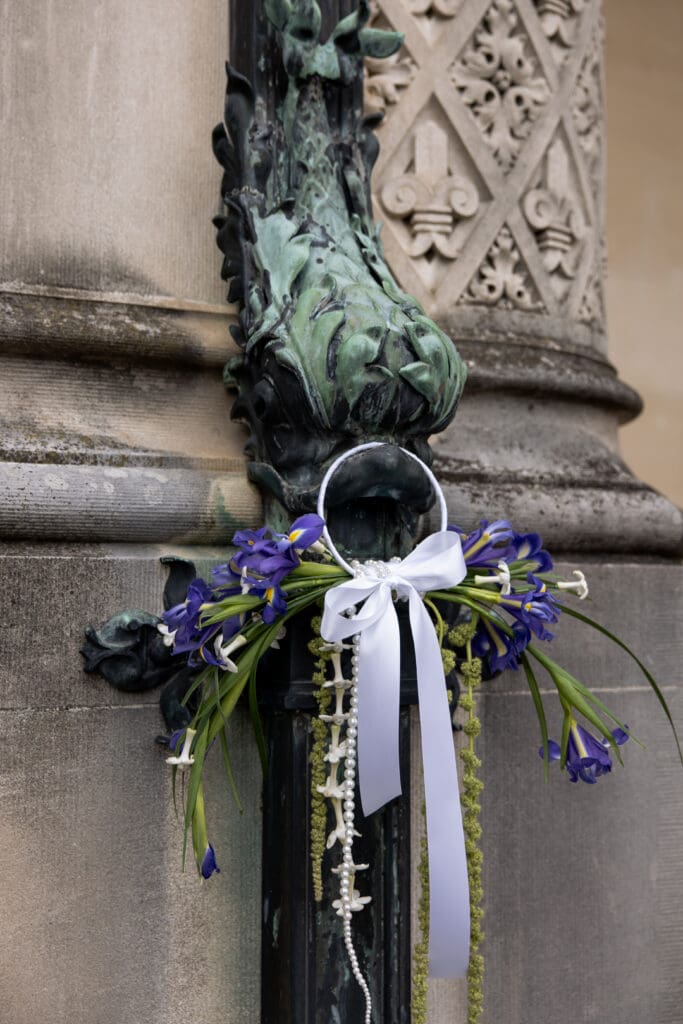 Elegant garden-inspired floral arrangement displayed on the stone railing at the Biltmore Estate, part of editorial Biltmore wedding photos.