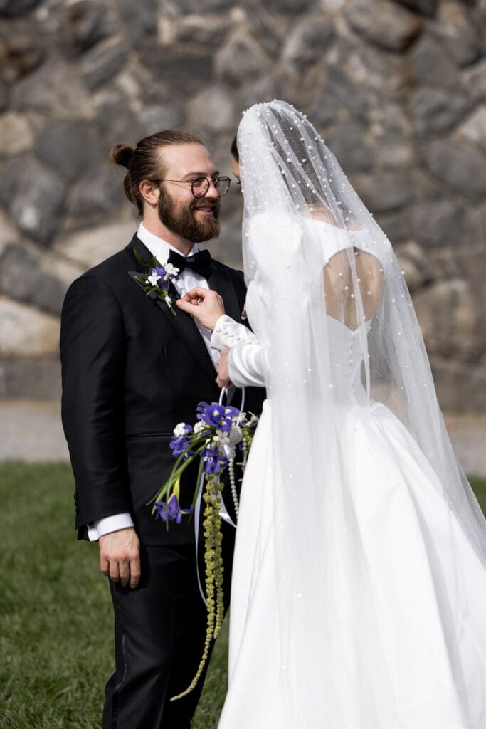 Groom smiling at his bride during their wedding portraits on the grounds of the Biltmore Estate.