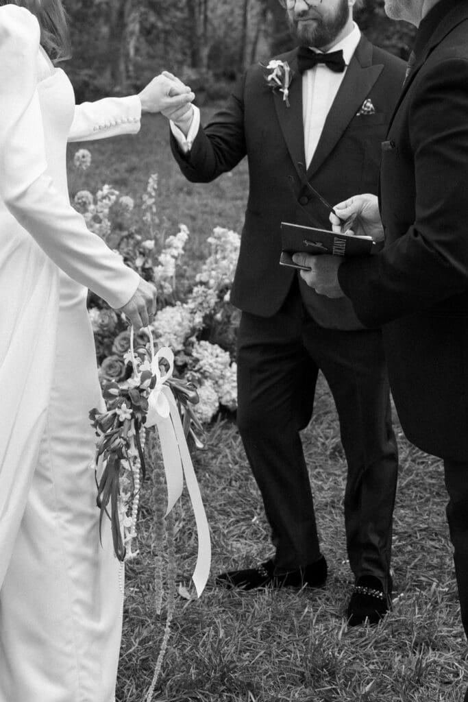 Black-and-white candid moment of bride and groom at the alter together at the Biltmore Estate, captured by a Biltmore wedding photographer.