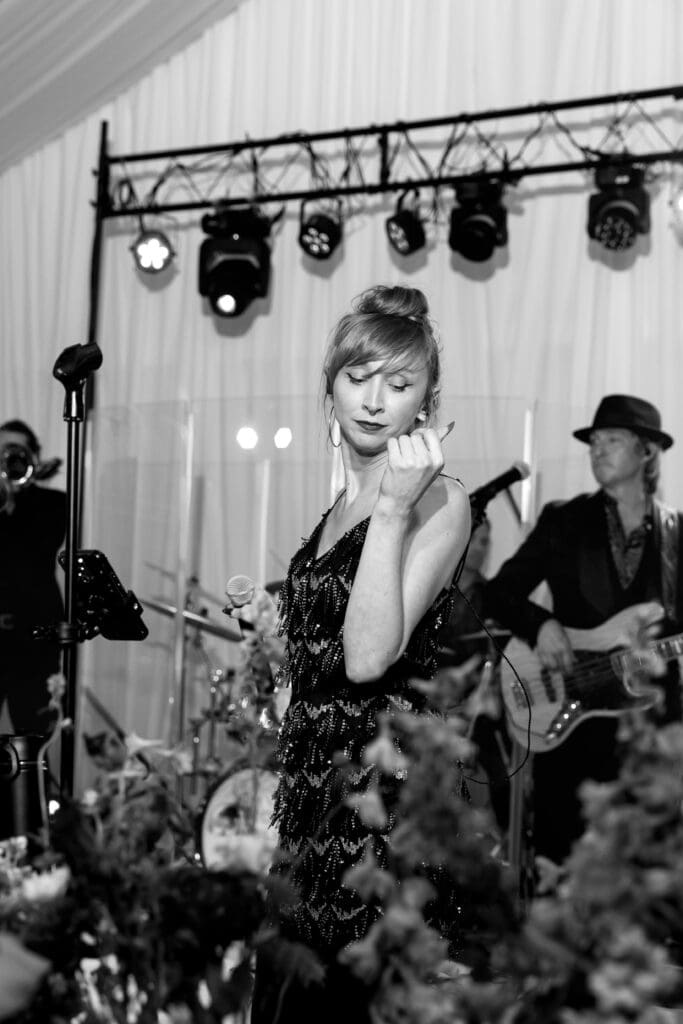 Live band singer performing during the Biltmore Estate wedding reception, captured in classic black-and-white.”