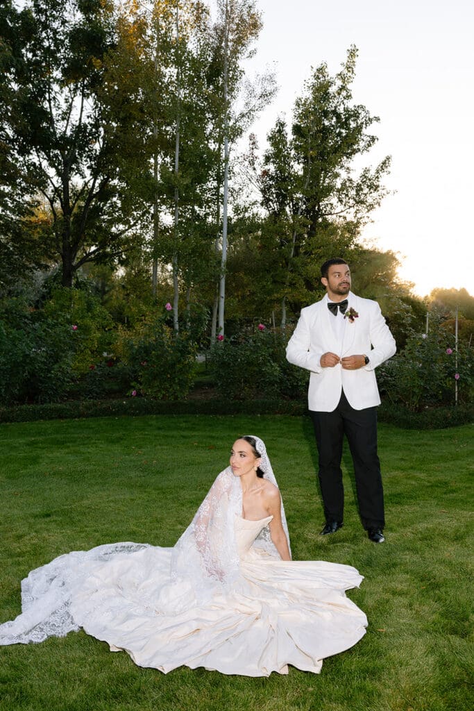 Bride seated on lawn with full gown and extended train during editorial portrait session in Boulder.