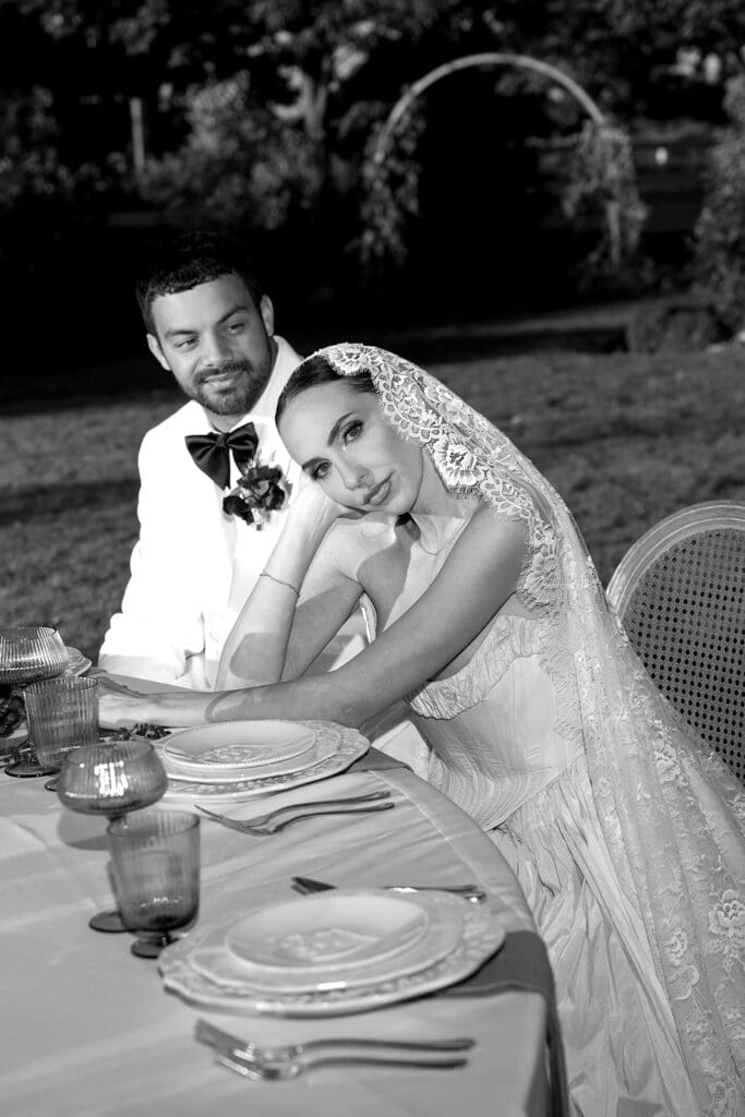 Black and white wedding portrait of couple dining at Oceana’s Gardens captured by editorial wedding photographer.