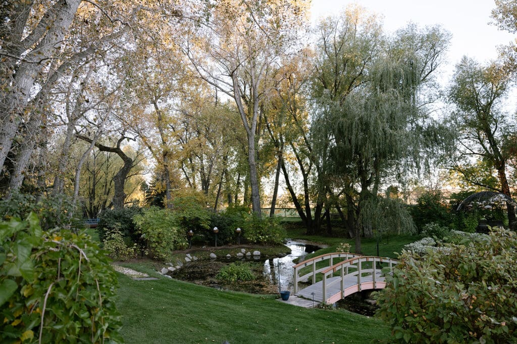 Scenic creek and white bridge at Oceana’s Gardens wedding venue in Boulder, Colorado.