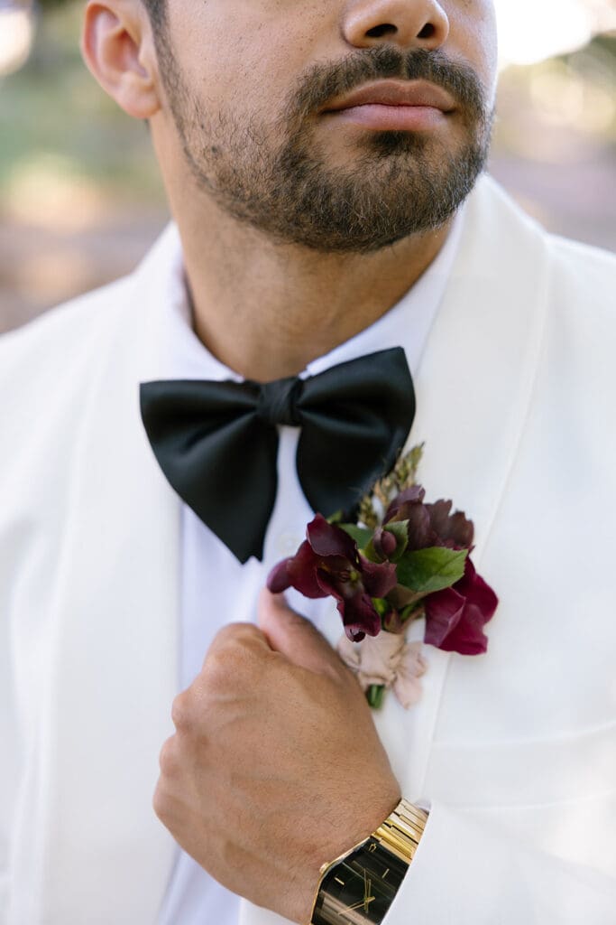 Close-up of groom’s boutonniere and tuxedo details at Oceana’s Gardens wedding in Boulder.