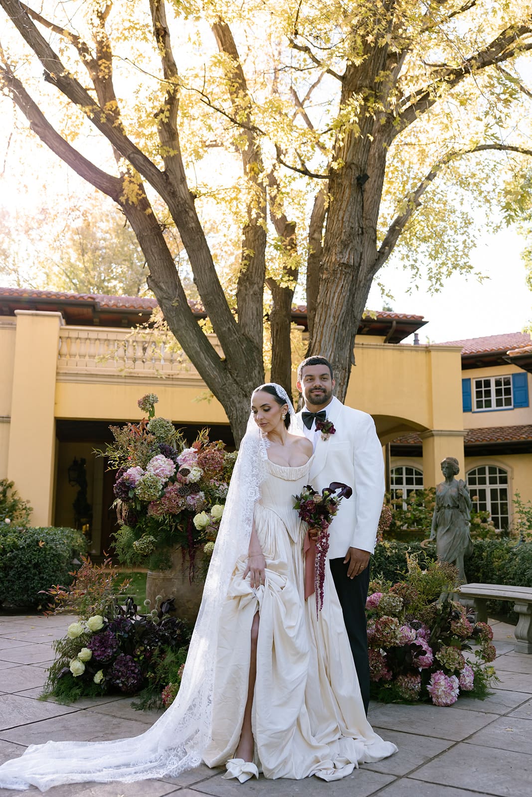 Bride and groom standing together in the courtyard at Oceana’s Gardens wedding venue.