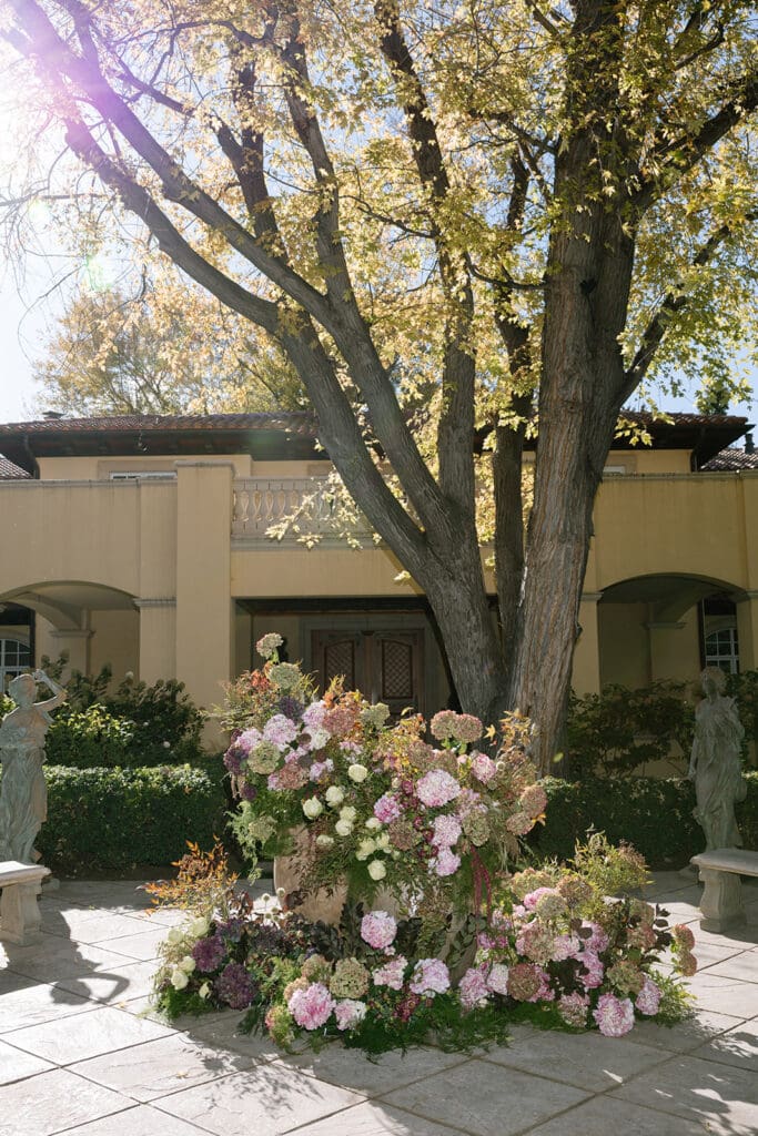 Large floral installation in the courtyard at Oceana’s Gardens with European-style architecture.