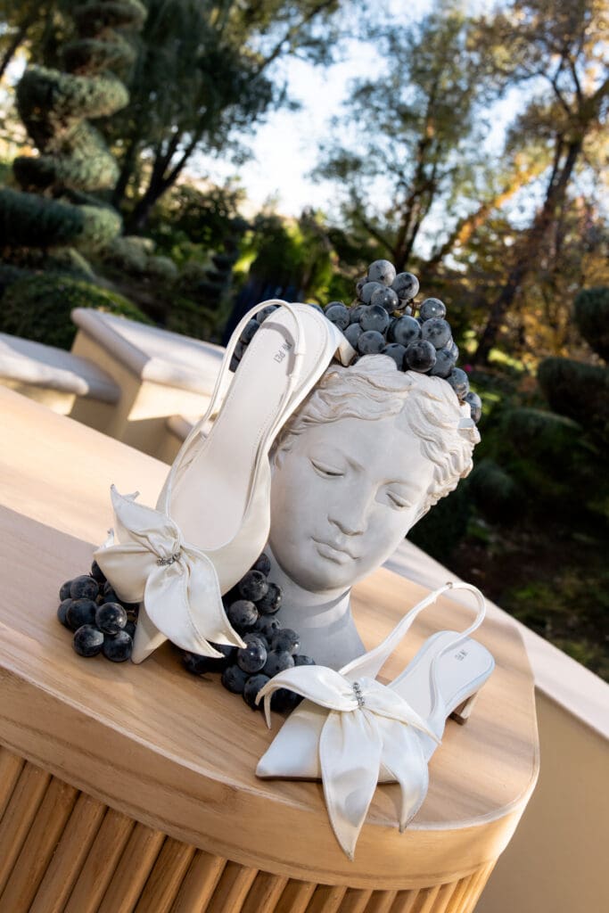 Bridal shoes styled on classical sculpture at Oceana’s Gardens wedding venue.