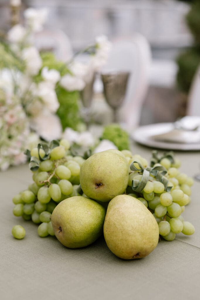 Elegant European-inspired wedding tablescape featuring pears, grapes, and organic floral design at Stone Mountain Estate, photographed by Malibu CA wedding photographer.