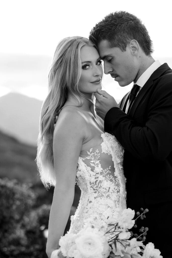 Editorial black-and-white bridal portrait featuring the couple embracing with dramatic mountain views at Stone Mountain Estate, captured by a Malibu CA wedding photographer.