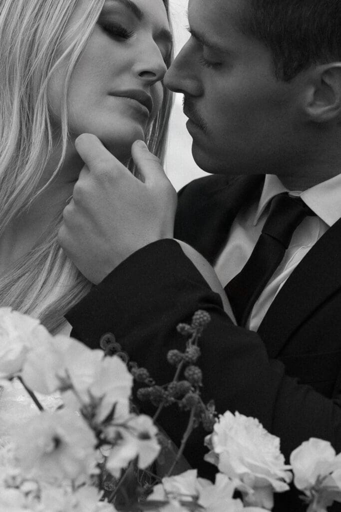 ntimate black-and-white editorial portrait of a bride and groom surrounded by soft florals at Stone Mountain Estate, captured by a Malibu CA wedding photographer.
