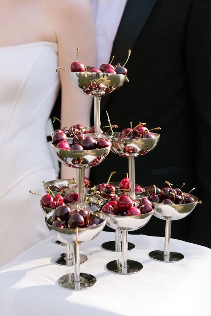 Editorial champagne tower with cherries styled for Santa Barbara outdoor destination wedding.