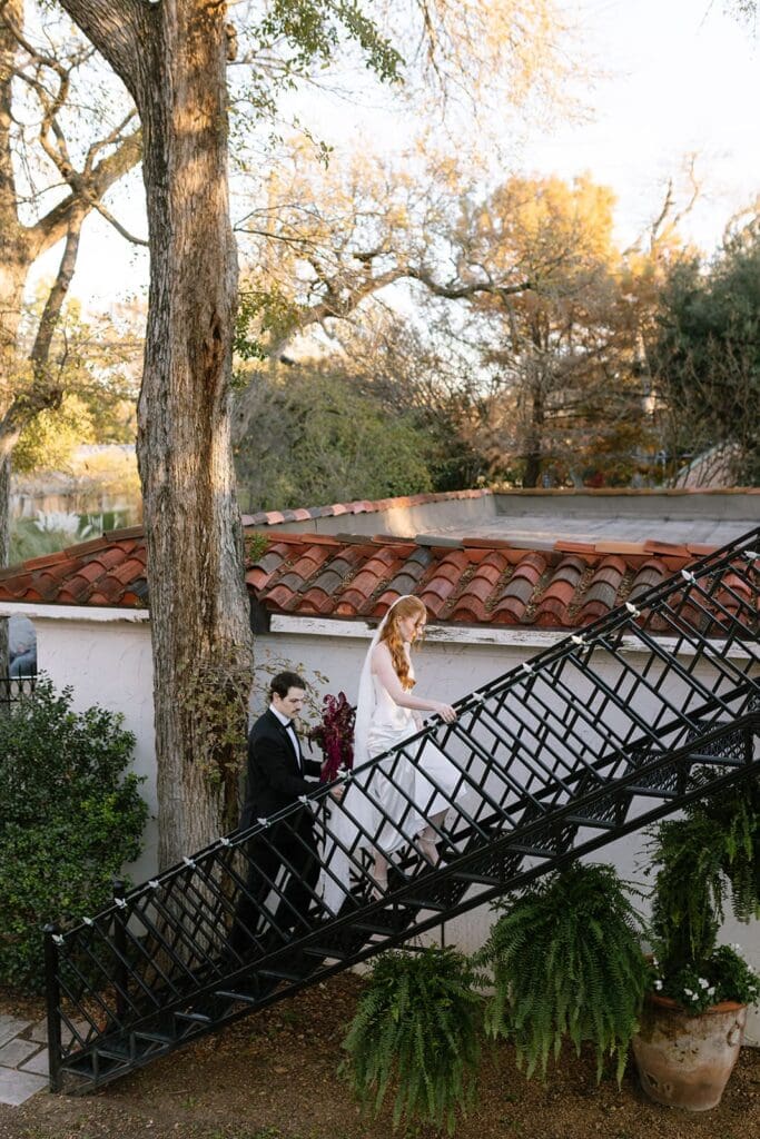 Bride and groom walking down outdoor staircase at Santa Barbara estate wedding venue.