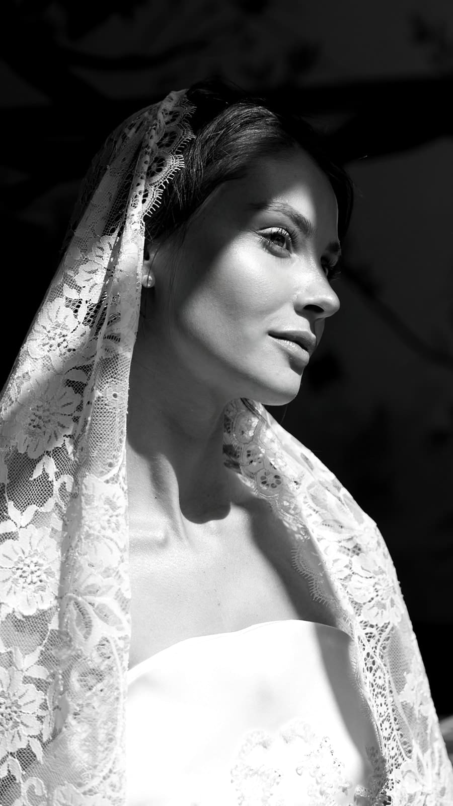 Black and white editorial bridal portrait with lace veil detail, intimate and timeless luxury wedding photography in Rome