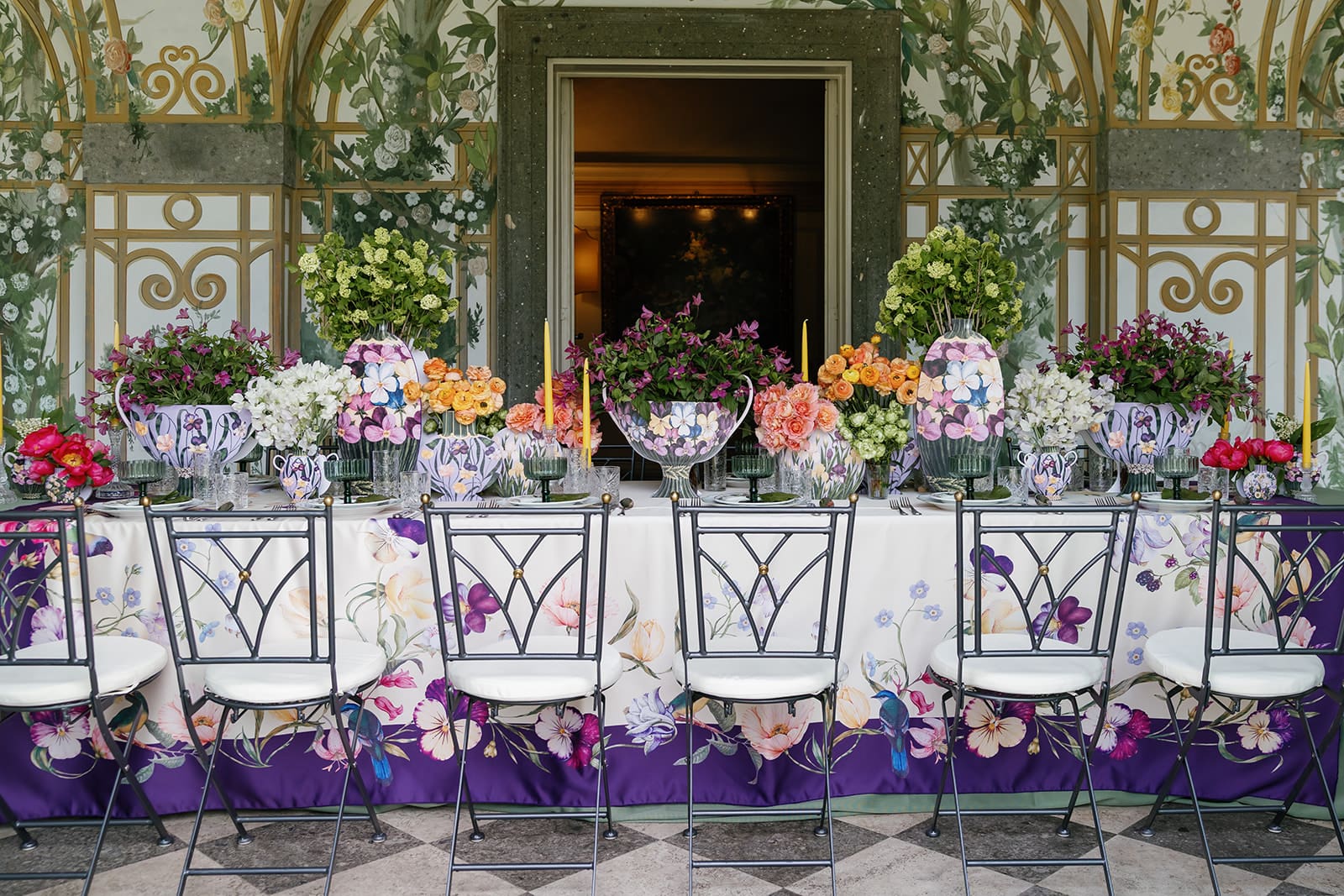 Luxury destination wedding reception in Rome with vibrant floral design, botanical wallpaper backdrop, and elegant table settings, photographed by editorial wedding photographer Frazier & Co., design by Birch Events and Design