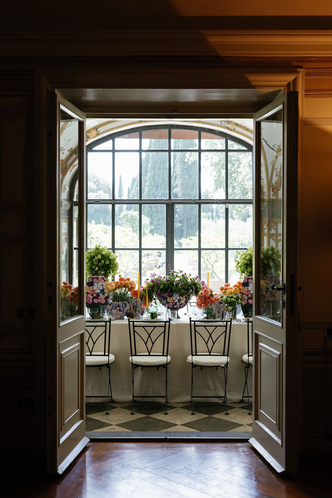 Classical conservatory interior with arched ceilings, botanical wallpaper, and warm architectural lighting at luxury Rome destination wedding venue