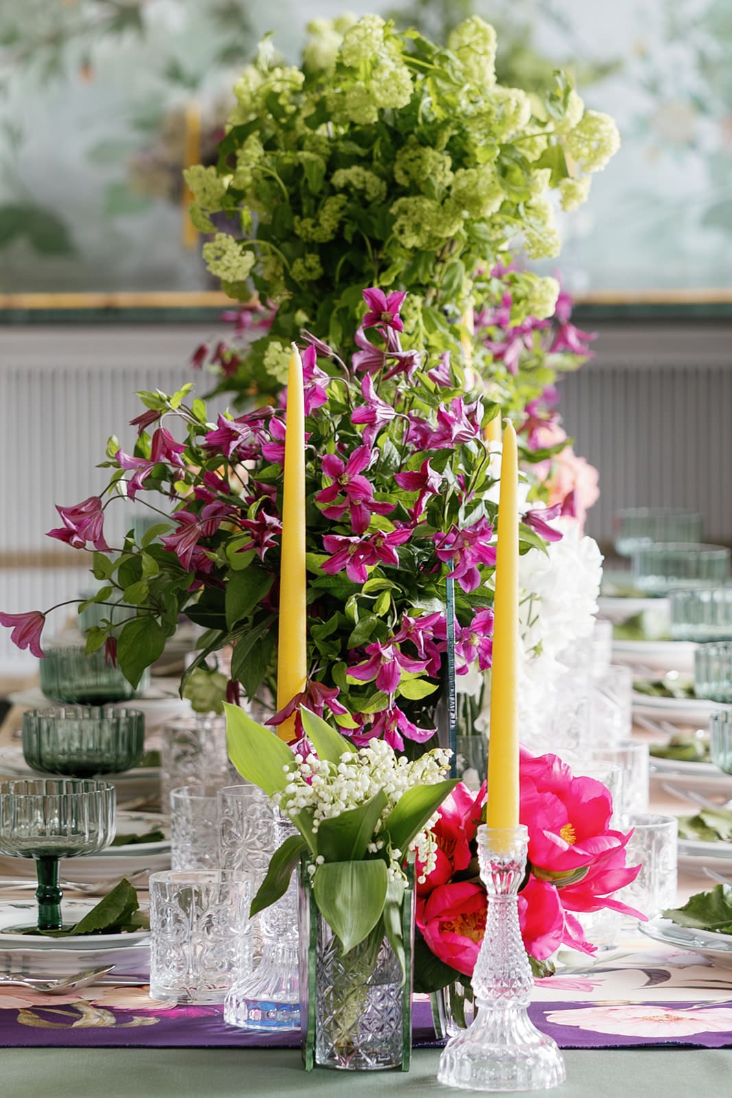 Hanging floral installation with fuchsia pink flowers and lush greenery, suspended flower arrangement for luxury Rome destination wedding reception