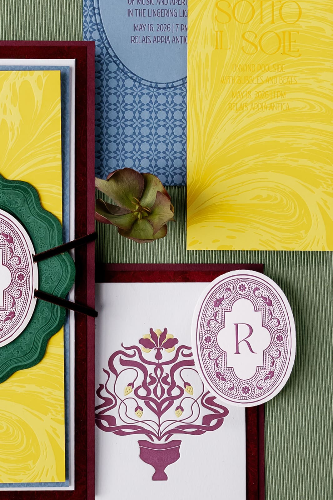 Luxury wedding stationery suite with yellow, burgundy, and blue botanical elements, monogram design, and custom invitation details for Rome destination wedding