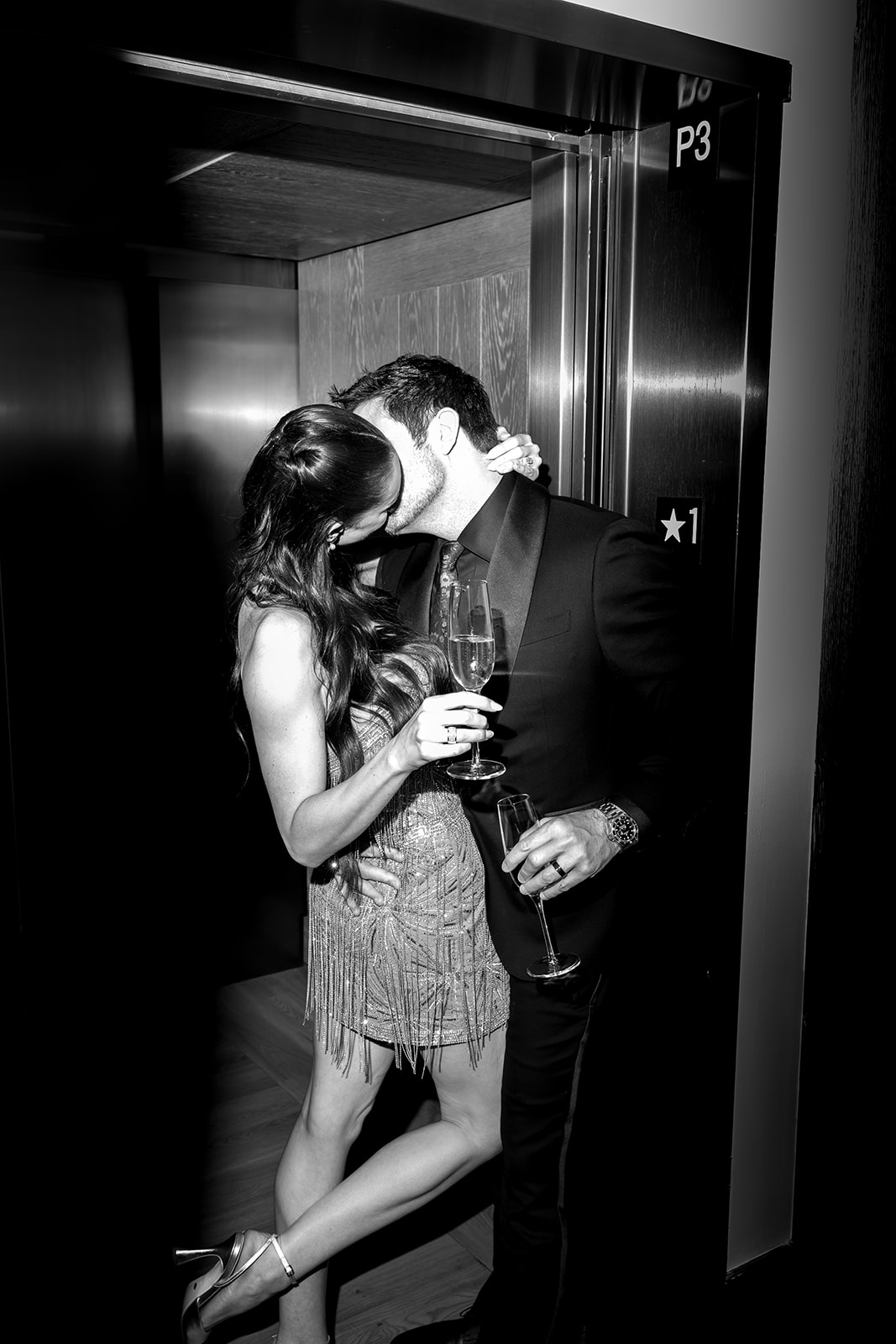 Black and white photo of bride and groom kissing in an elevator at Montage in Big Sky, Montana