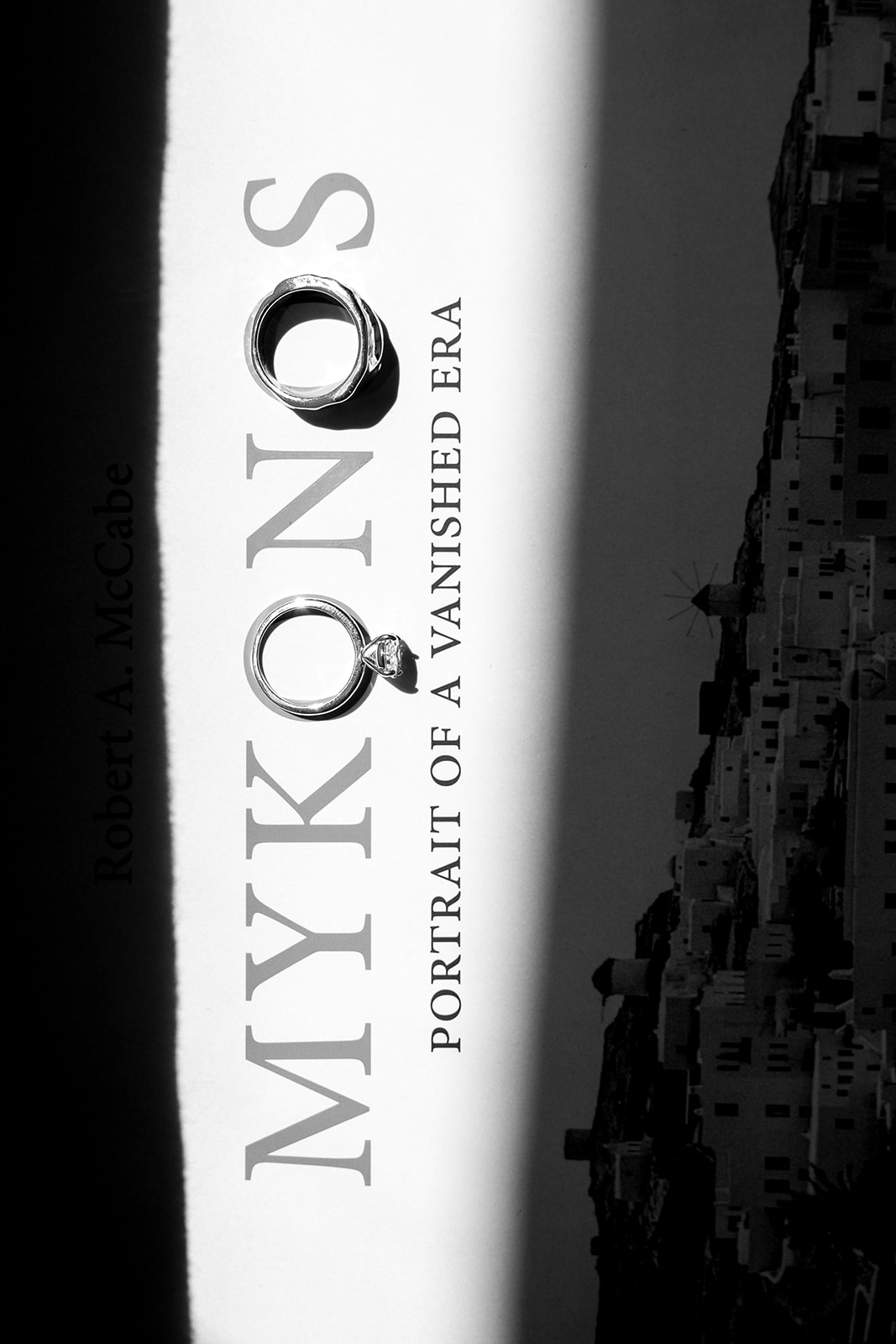 Black and white editorial photograph of a luxury wedding publication featuring the name Mykonos